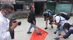 Tibetan Activist Tenzin Tsundue stomps on the Chinese flag to protest against the PLA incursion into Ladakh and the death of 20 Indian soldiers. (June 18, 2020 Phayul photo-Kunsang Gashon).