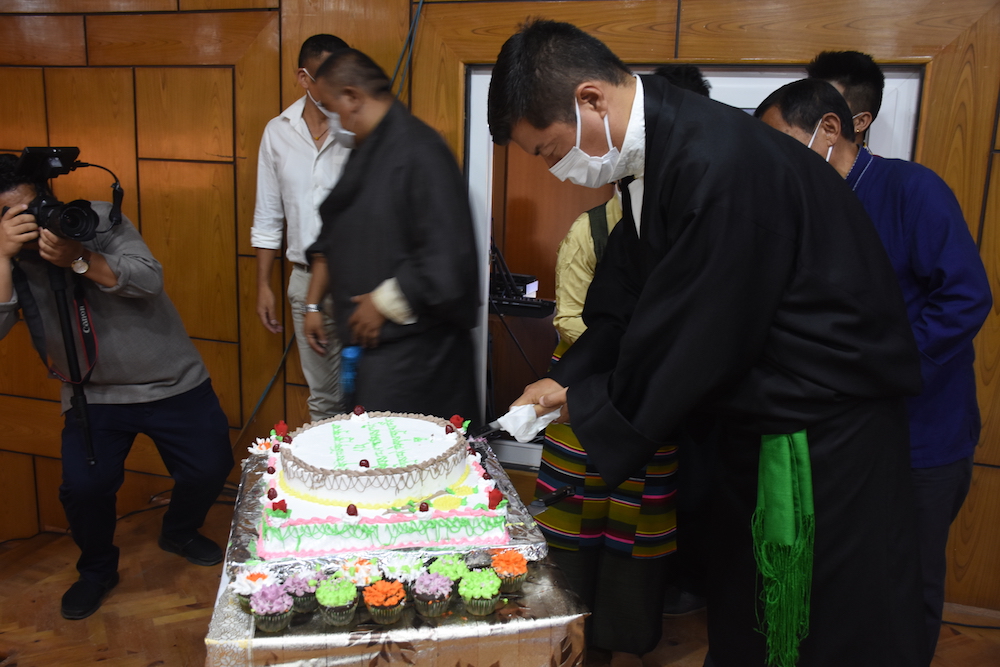 CTA President cutting a celebratory cake at Gankyi hall on HHDL's 85th birthday (Phayul Photo Kunsang Gashon)