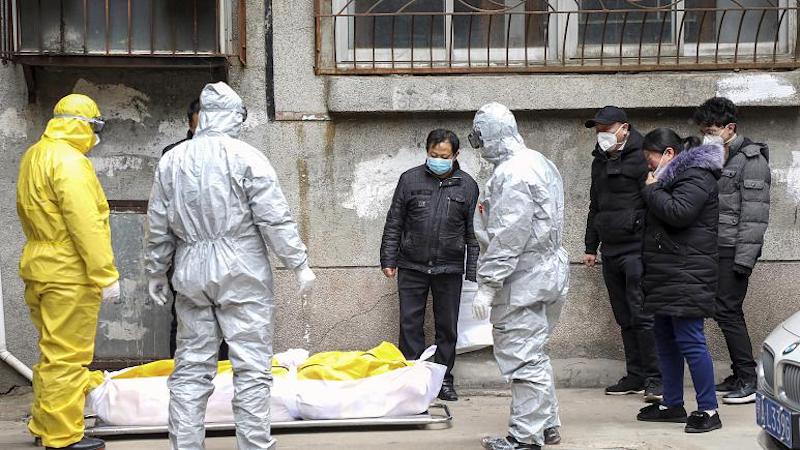Frontline funeral workers remove the body suspected to have died from COVID-19 at Wuhan in Feb 2020 (Photo- AP)