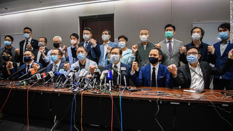Pro-democracy lawmakers join hands in soldarity with the four ousted MPs at a press conference in Hong Kong on Wednesday (Photo- CNN)