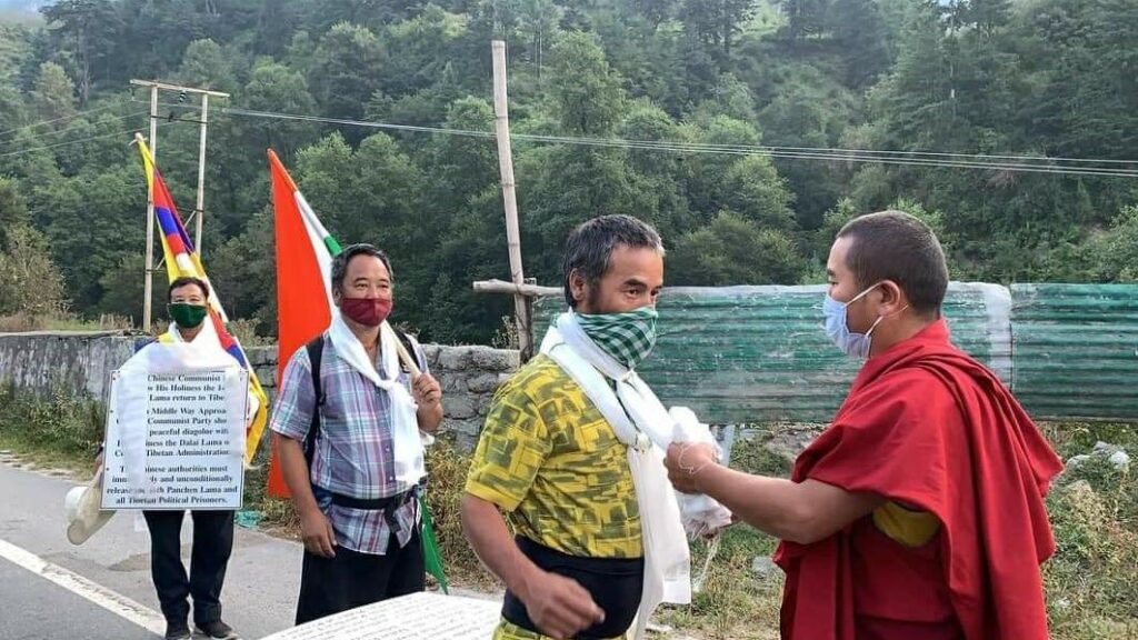 The three activists being felicitated by a monk at the beginning of the 'Peace March' on Wednesday (Phayul photo)