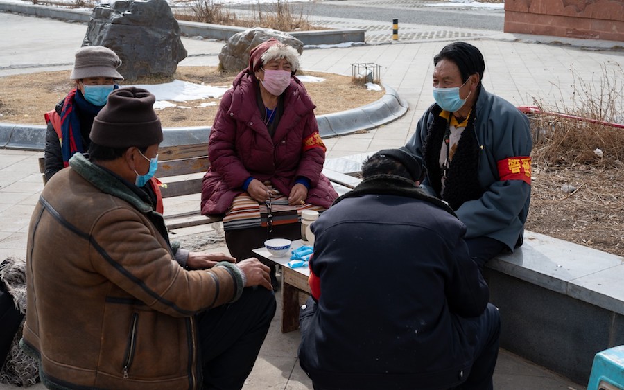 Tibetan virus prevention workers take a break in Garze, Occupied Tibet. Photo-LA Times:Eleanor Moseman