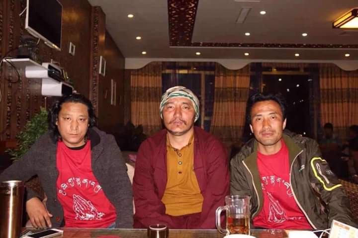 Choekyi flanked by former Tibetan political prisoners wearing the T-shirts made for Dalai Lama’s 80th birthday by Choekyi. Photo-TCHRD